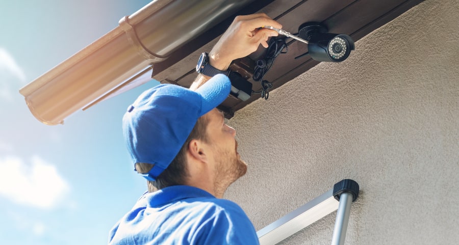 Man installing surveillance camera