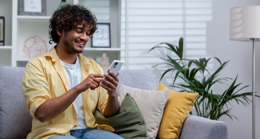 Homeowner navigating a home security app on his mobile device